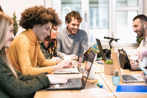 Grupo de pessoas trabalhando em laptops em equipe